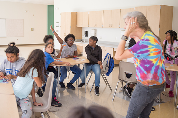 Teacher interacting with students in classroom